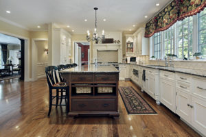 DDBuild-A new custom Chef's style kitchen with white cabinets, chestnut color kitchen Island and oak floors